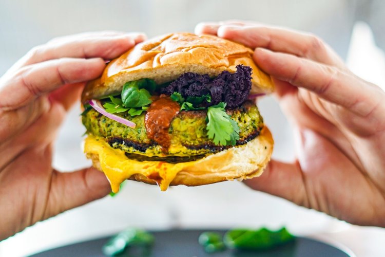 Green lentil, feta, chickpea and spice bomb burger with turmeric and harissa yoghurt.only.