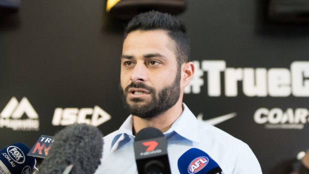 AFL diversity officer Ali Fahour reads a statement after attacking another player.