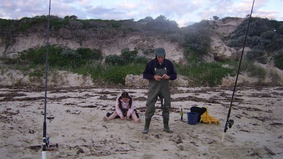 Ms Clifton's father and niece fish on the remains of the beach, with its former height seen in the background. 