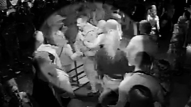 A policeman dancing with a woman at Inflation nightclub.