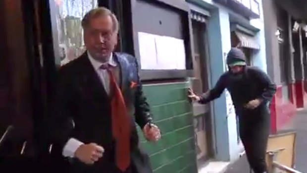 Andrew Bolt fights back against assailants on the streets of Carlton in Melbourne.
