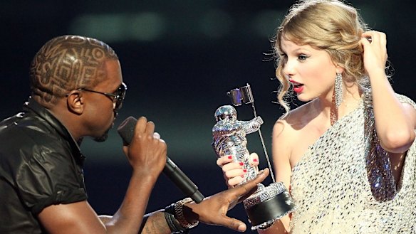 Kanye West takes the microphone from Taylor Swift as she accepted a VMA in 2009.
