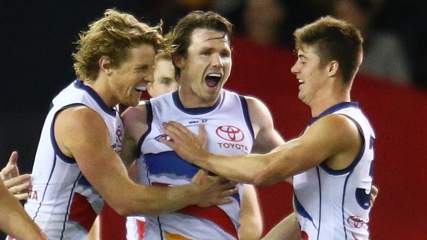 Crows star Patrick Dangerfield (centre)  celebrates after kicking a goal in the huge victory over Essendon.