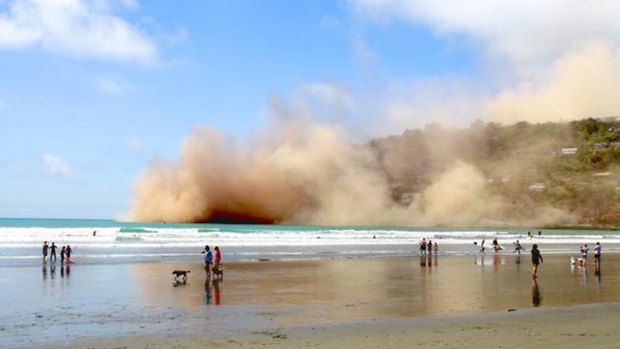 Dust clouds rise in Sumner following the collapse of a cliff during Sunday's large earthquake. 