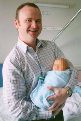 Dr Oliver Brown holds a baby in a photo posted to his Facebook page.