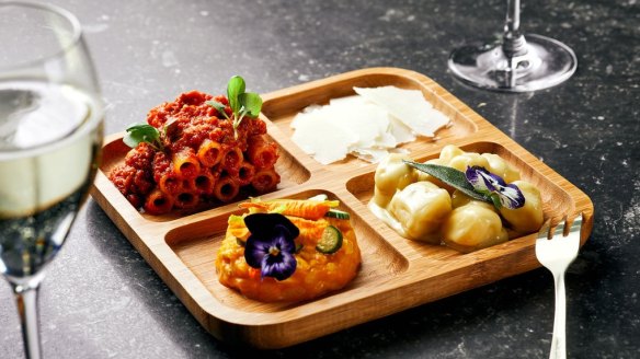 Mixed pasta plate, gnocchi four cheeses, candele bolognese and pumpkin and crab risotto with zucchini flowers.