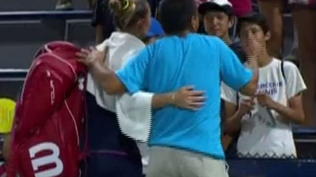 A fan is arrested after jumping on court for a selfie with Kateryna Bondarenko at the US Open.
