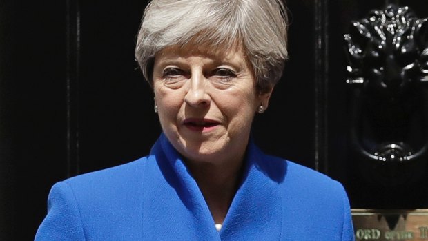 Prime Minister Theresa May (left) with her husband, Philip, stand in front of No. 10 Downing Street. She promised 'strong and stable government' throughout the election campaign. 