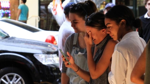 Friends of Cole Miller grieve his death at a vigil in Chinatown Mall.