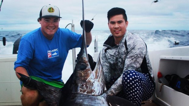 Tien Nguyen and Doug Robertson with the swordfish. 