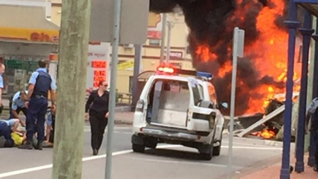 Police pinned the driver down as a fireball erupted nearby.