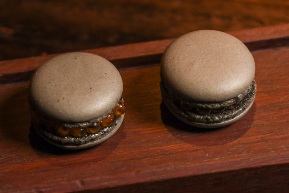 Signature black garlic macarons filled with salmon roe are available in the restaurant and its adjacent bar.