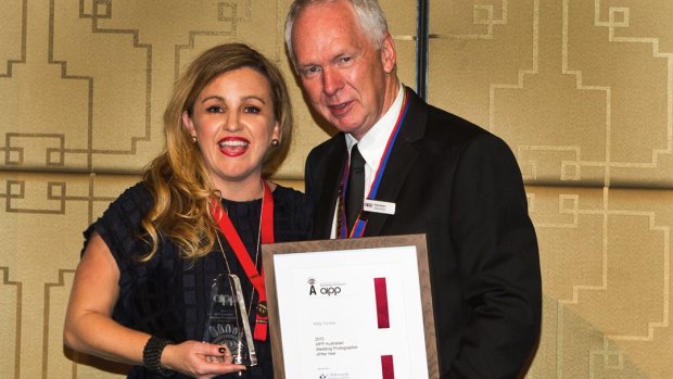 Canberra wedding photographer Kelly Tunney accepting her award from Ross Eason, national president of the Australian Institute of Professional Photographers.