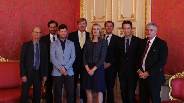 King Willem-Alexander, centre back in gold tie, with Australian journalists including Nick Miller, second left, at the Noordeinde Palace's Cherub Room.