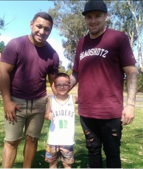 Josh Papalii and Blake Austin with Raiders fan Jayden Jacobs at his seventh birthday party in Sydney last year.