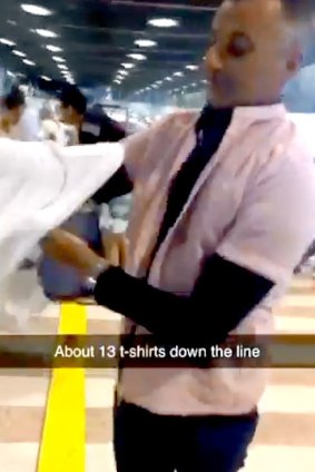 Josh Irvine's video of his dad, John, putting on layers of clothes to avoid excess baggage fees has gone viral on Twitter.
