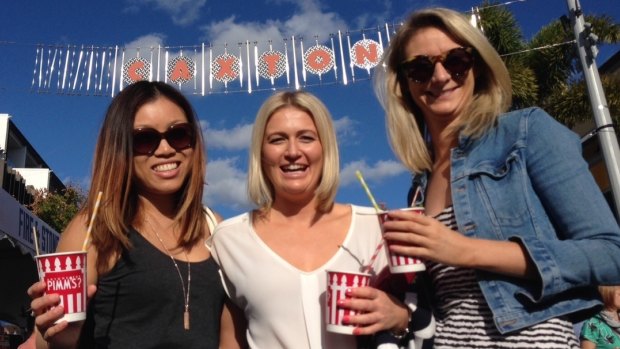 Debbie Ky from Sydney, Summer Kovacs and Emily Kennedy from Melbourne celebrate the fine weather at the Caxton Street Festival