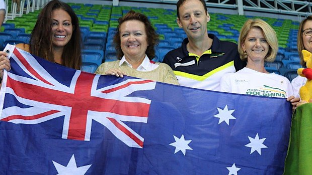 Gina Rinehart and others holding up an Australian flag at the Rio olympics in Brazil