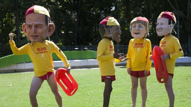 Oxfam activists dressed as world leaders in lifeguard uniforms during a protest in Brisbane on Friday.