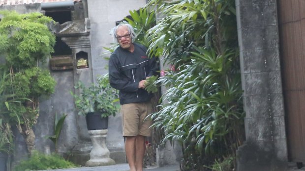 A masked man, possibly Schapelle Corby's brother Michael, outside the villa where Schapelle has been living while on parole