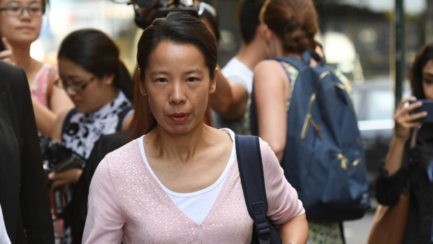 Kathy Lin, the wife of Robert Xie, leaves court on Friday.