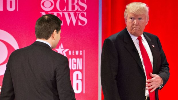 Donald Trump looks toward Senator Marco Rubio during a break at the Republican presidential candidate.