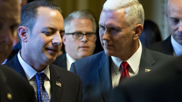 US Vice-President-elect Mike Pence talks to Reince Priebus.