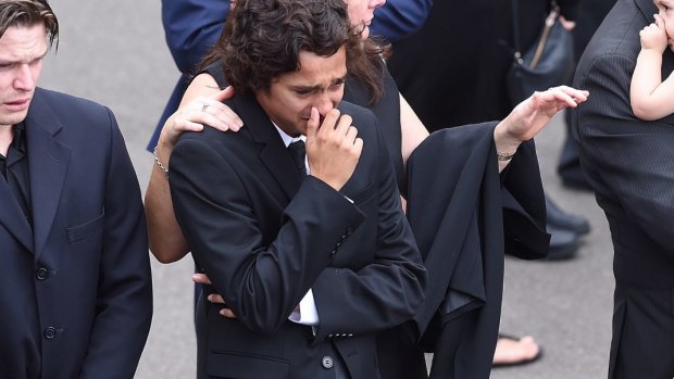 Jordan Brohier  is comforted moments after carrying the coffin of his girlfriend Annabelle Falkholt at St Mary's Catholic Church.