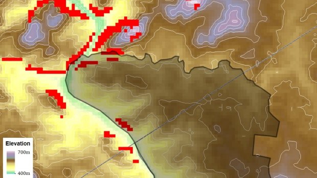 Map of elevation around the Ginninderry region, with the land subject to rezoning in dark shading. The red pixels indicate locations with slopes above 20°, that are prone to extreme fire behaviour.