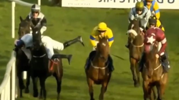 Great escape: Jack Kennedy attempts to get back in the saddle after being bumped off his ride.