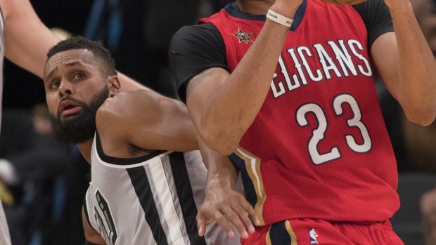 Patty Mills tangles with Anthony Davis.