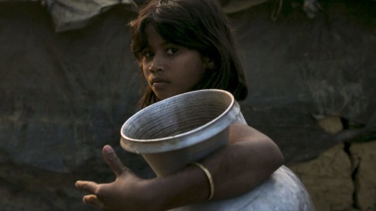 A girl carries a water jug in Kutapalong Rohingya refugee camp in Cox's Bazar, Bangladesh. 