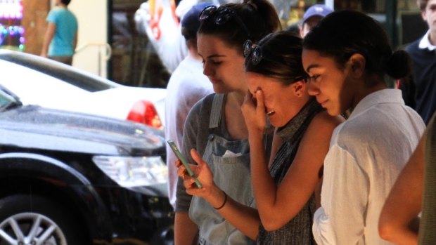 Friends of Cole Miller grieve his death at a vigil in Chinatown Mall.