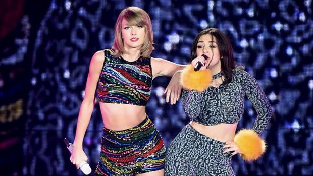 Taylor Swift and Charli XCX on stage wearing boohoo. 