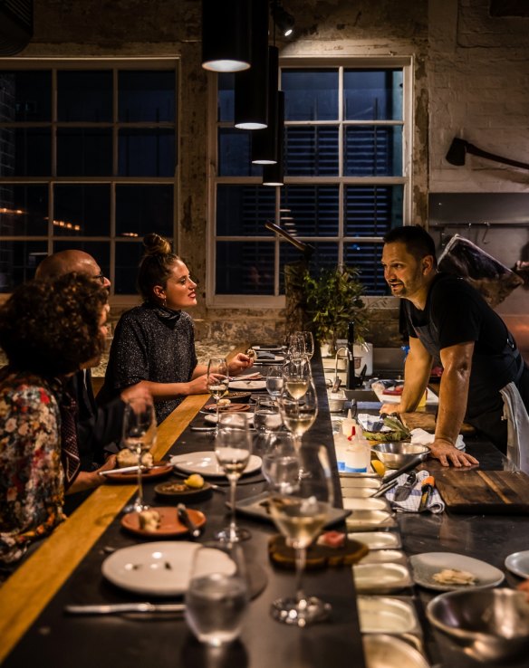 Firedoor chef Lennox Hastie chats to lone diners at the bar.