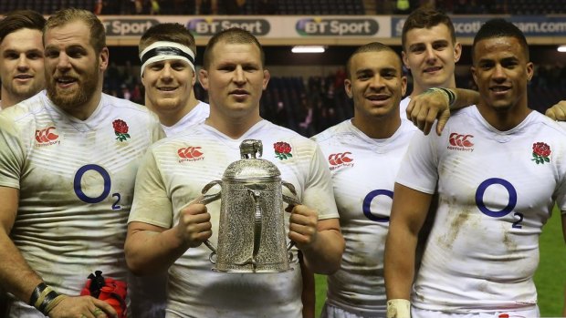 Off to a winning start: England players pose with the Calcutta Cup last weekend.