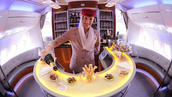 A flight attendant pours some Moet at Emirates’ Airbus A380 bar.