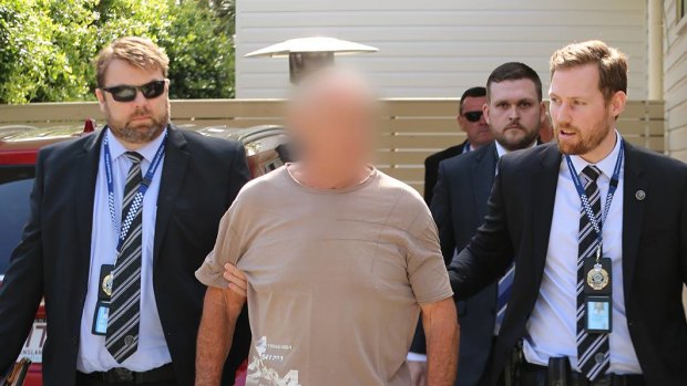 Queensland Police arrest Chris Dawson at a home on the Gold Coast on Wednesday morning. 