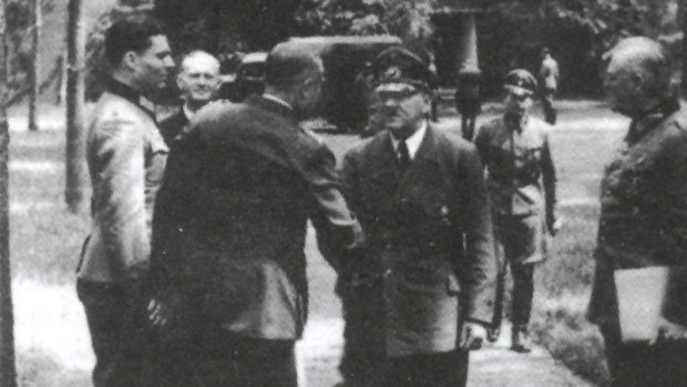 Hitler and Colonel Claus von Stauffenberg (extreme left), who later plotted to assassinate him.