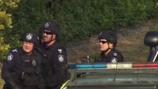 Senior Constable Izzard (centre) on the job.