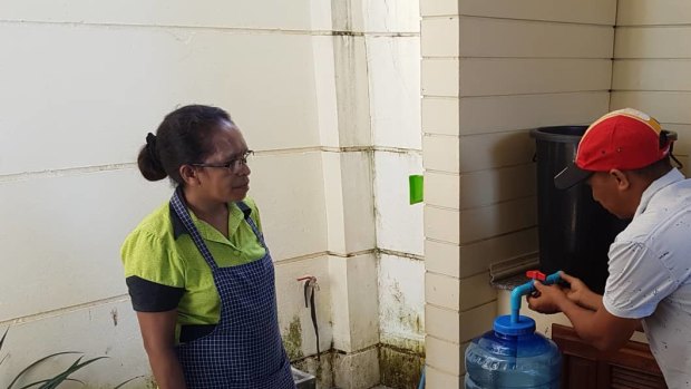Timorese trainee Joanico Da Silva installing a water filter at the home of the Ambassador to East Timor in Laos, Natália Carrascalão.