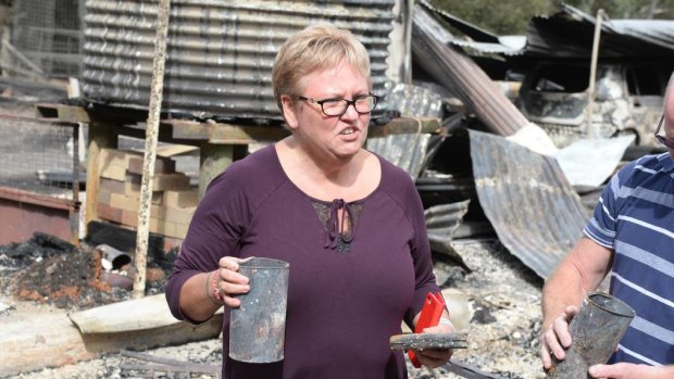 Heather Armstrong holds remaining pieces from her mother's home in Bunkers Hill.