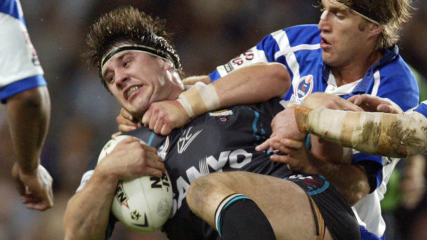 Former Penrith front-rower Martin Lang is rocked in a tackle against the Bulldogs in 2004.