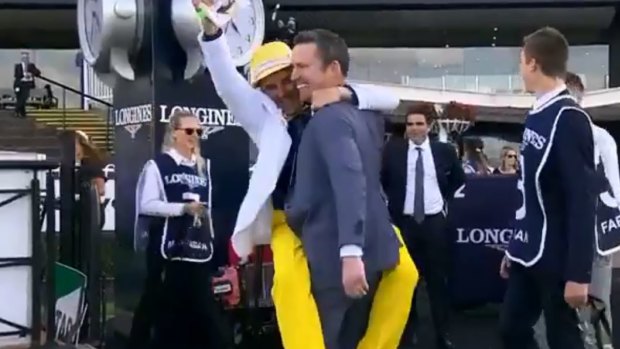 Neil Paine (yellow trousers) celebrates with Adrian Bott after winning Golden Slipper with Farnan.
