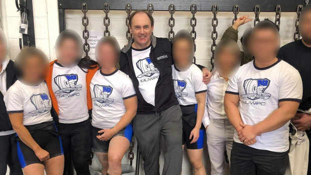 Powerlifting Australia’s national coaching director Robert Wilks, centre, has launched defamation proceedings against once of his female students.  