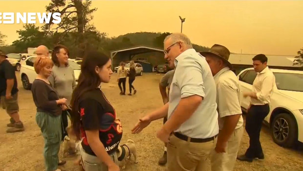 A young woman refuses to shake the hand of the Prime Minister during his visit to Cobargo.