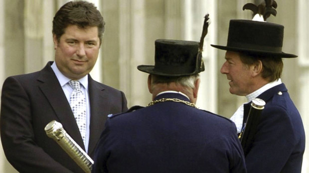 A 2004 file photo shows Michael Fawcett, left. the former close aide to Britain’s Prince Charles stepped down temporarily from his role as chief executive of a royal charity amid reports that he helped secure an honour for a Saudi donor.