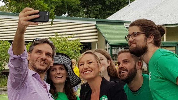 Queensland Greens senator Larissa Waters (centre) posing for a photo at Rainworth State School on Saturday with supporters and state member for Maiwar Michael Berkman.