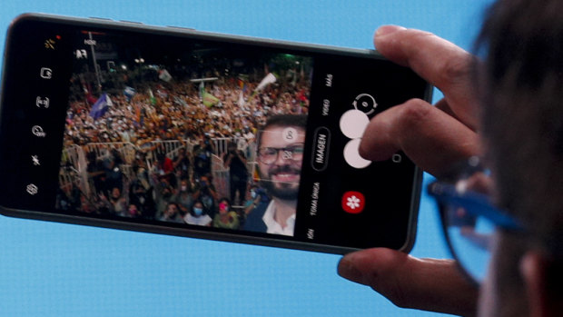 Chile’s President elect Gabriel Boric, of the “I approve Dignity” coalition, takes a selfie with his supporters after his victory in the presidential run-off election in Santiago.