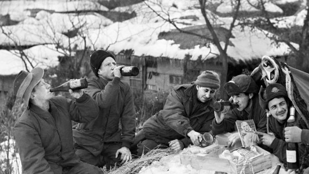 Australian troops enjoy a beer, food and Christmas parcels from the RSL during the Korean War.